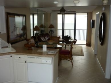 Open living room kitchen with balcony overlooking gulf